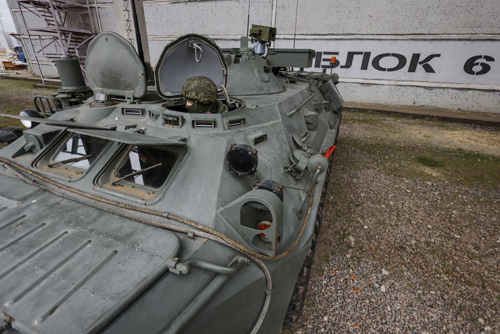 epa10549033 A picture taken during a visit to Enerhodar organized by the Russian military shows a Russian serviceman manning an armoured personnel carrier of the troops of chemical and biological protection monitoring the radiation situation at the Zaporizhzhia Nuclear Power Plant (ZNPP) during a visit by International Atomic Energy Agency (IAEA) Director-General Rafael Mariano Grossi in Enerhodar, southeastern Ukraine, 29 March 2023. According to Ukrainian national nuclear energy company Energoatom, 'Grossi plans to see how the situation at the ZNPP has changed, talk to the staff working there, and act as a guarantor of the rotation of members of the IAEA’s permanent mission, which has been at the ZNPP since September  EPA/SERGEI ILNITSKY