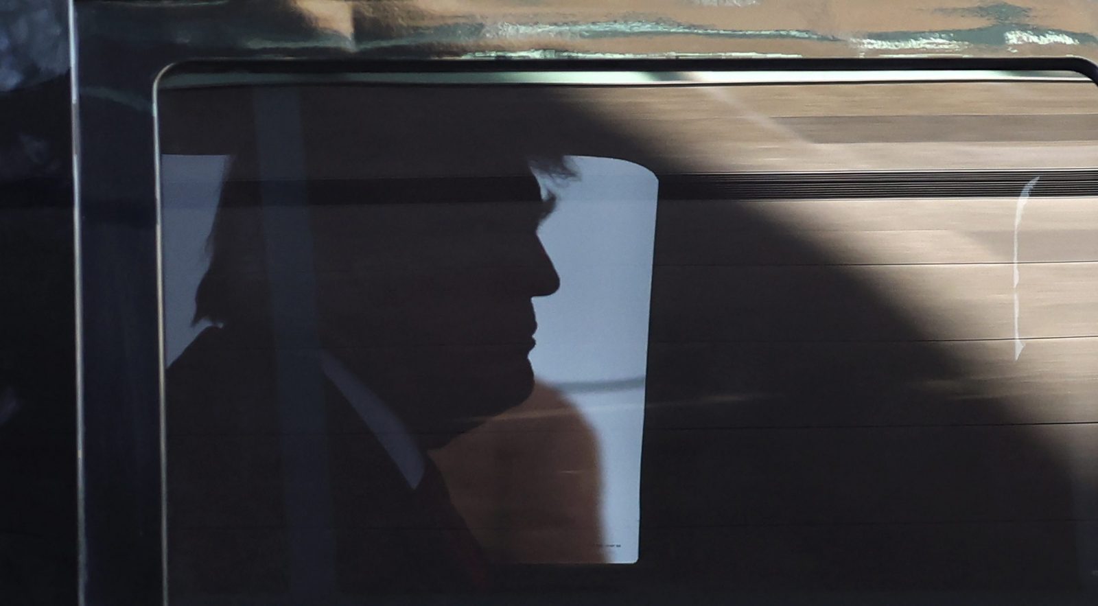 epa10557456 Former US President Donald J. Trump in the back of his armored SUV as he arrives at Trump Tower in New York, New York, USA, 03 April 2023. After being indicted by a Manhattan grand jury last week, former US President Donald J. Trump is traveling to New York 03 April and will reportedly turn himself in on 04 April at New York Criminal Court to hear the charges against him.  EPA/CJ GUNTHER