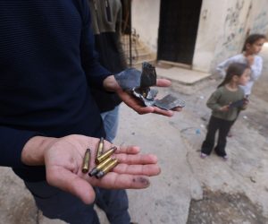 epa10578541 A person holds bullet casings following clashes that erupted during an Israeli Army operation at a refugee camp near Jenin, 18 April 2023. According to the Palestinian Health Ministry, three Palestinians were arrested and at least five others were wounded. Israeli forces said the raid was conducted to arrest two suspected terrorists.  EPA/ALAA BADARNEH