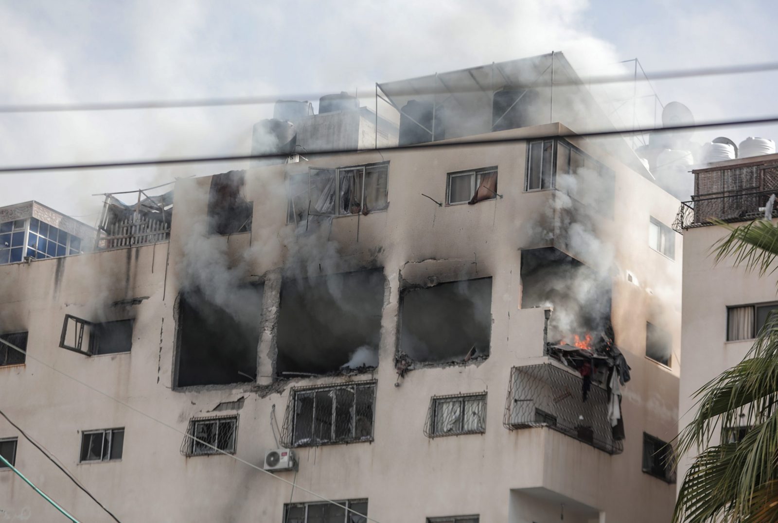 epa10623308 Smoke comes out from the department of Iyad Al-Hasani, the leader of Al-Quds Brigades, the armed wing of the Palestinian Islamic Jihad, after an Israeli air strike in Gaza city, 12 May 2023. According to Israel Defense Forces, Al-Hasani and his bodyguard were killed after the Israeli air strike.  EPA/HAITHAM IMAD