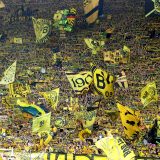 epa10657396 Fans of Borussia Dortmund wave flags before the German Bundesliga match between Borussia Dortmund and Mainz 05 in Dortmund, Germany, 27 May 2023.  EPA/FRIEDEMANN VOGEL (ATTENTION: The DFL regulations prohibit any use of photographs as image sequences and/or quasi-video.)