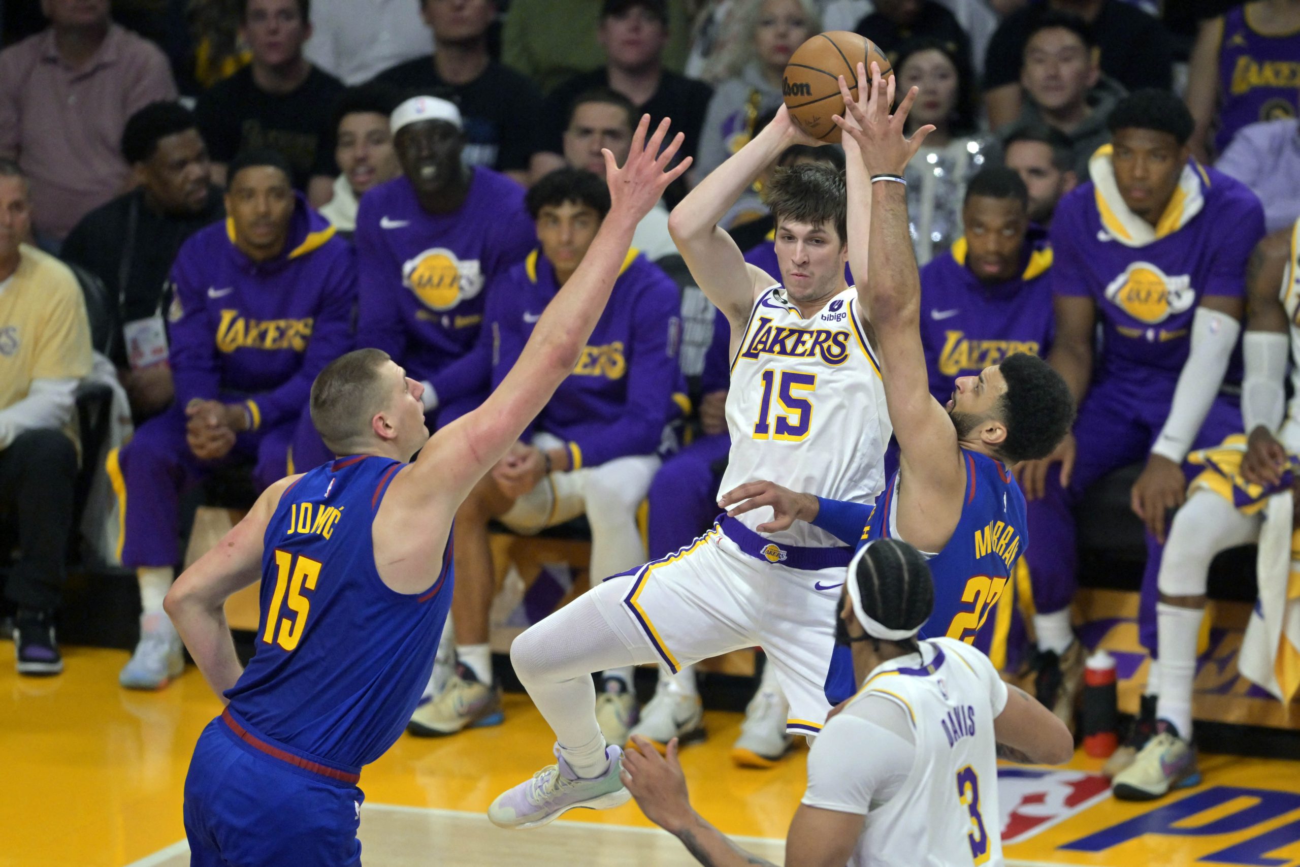 May 20, 2023; Los Angeles, California, USA; Los Angeles Lakers guard Austin Reaves (15) shoots against Denver Nuggets guard Jamal Murray (27) and center Nikola Jokic (15) in the first half during game three of the Western Conference Finals for the 2023 NBA playoffs at Crypto.com Arena. Mandatory Credit: Jayne Kamin-Oncea-USA TODAY Sports Photo: Jayne Kamin-Oncea/REUTERS