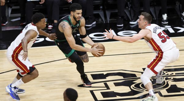 May 21, 2023; Miami, Florida, USA; Boston Celtics forward Jayson Tatum (0) dribbles against Miami Heat guard Kyle Lowry (7) and forward Duncan Robinson (55) during the first half in game three of the Eastern Conference Finals for the 2023 NBA playoffs at Kaseya Center. Mandatory Credit: Sam Navarro-USA TODAY Sports Photo: Sam Navarro/REUTERS