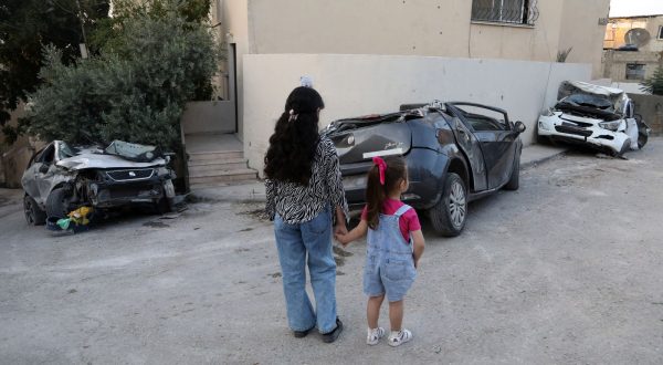 epa10732869 Palestinian children look at damaged cars at Jenin refugee camp, after an Israeli army raid in the West Bank city of Jenin, 07 July 2023. The Israeli army announced on 05 July the withdrawal of its soldiers from Jenin, after launching a large-scale operation two days earlier. According to the Palestinian Health Ministry, 12 Palestinians were killed and dozens of others wounded in the raid. The Israeli Defense Forces (IDF) also announced the death of 'a non-commissioned officer in combat service' during the raid.  EPA/ALAA BADARNEH