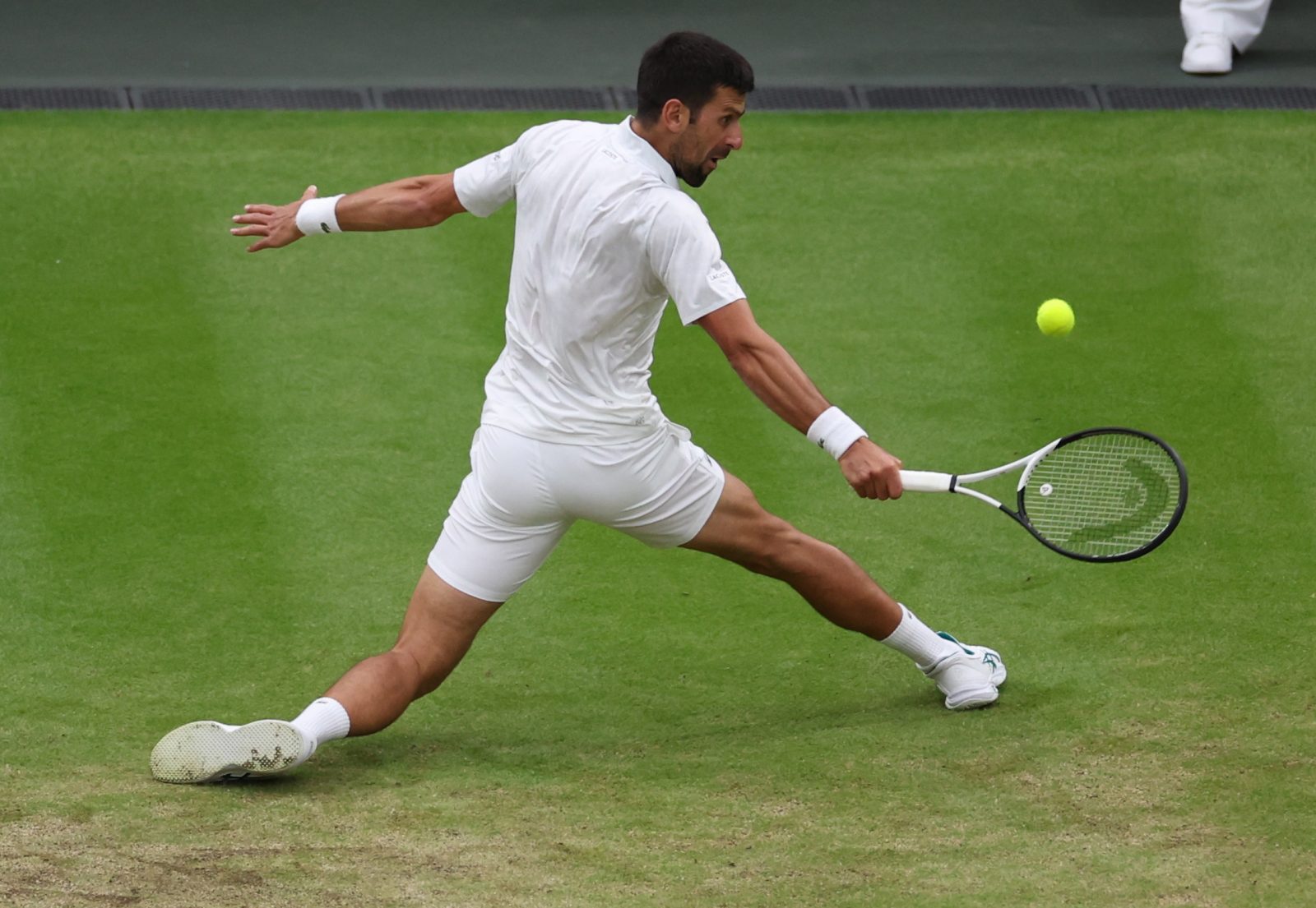 epa10746065 Novak Djokovic of Serbia in action during his Men's Singles semi-final match against Jannik Sinnner of Italy at the Wimbledon Championships, Wimbledon, 14 July 2023.  EPA/ISABEL INFANTES   EDITORIAL USE ONLY