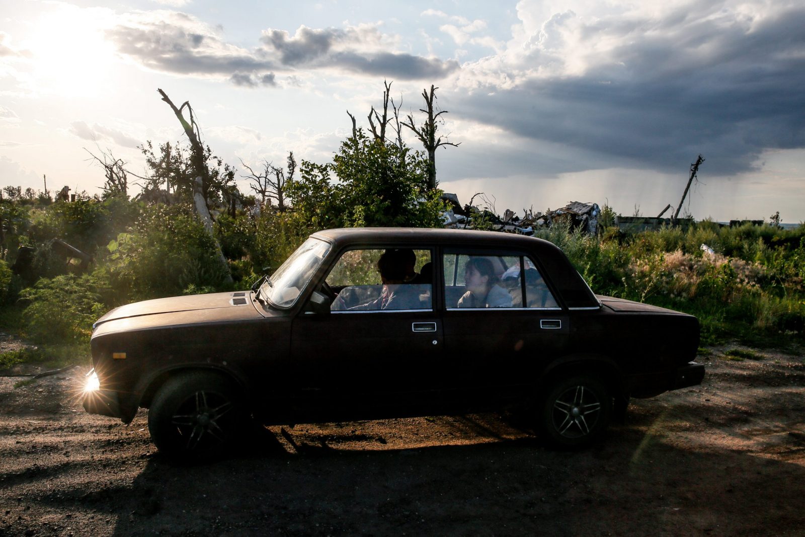 epa10748532 Mykola (41) and his family drive in Dovhenke village, Kharkiv region, Ukraine, 15 July 2023. Mykola came to his sister's destroyed family home to collect the rest of an apiary damaged during active combat in Russia's ongoing invasion of Ukraine. His own home in nearby Krasnopillia village was also destroyed during the fighting, and he was forced to move with his family to Khrestyshe, where he keeps bees and hopes to one day return home. Russian troops entered Ukraine on 24 February 2022, starting a conflict that has provoked destruction and a humanitarian crisis.  EPA/OLEG PETRASYUK  ATTENTION: This Image is part of a PHOTO SET