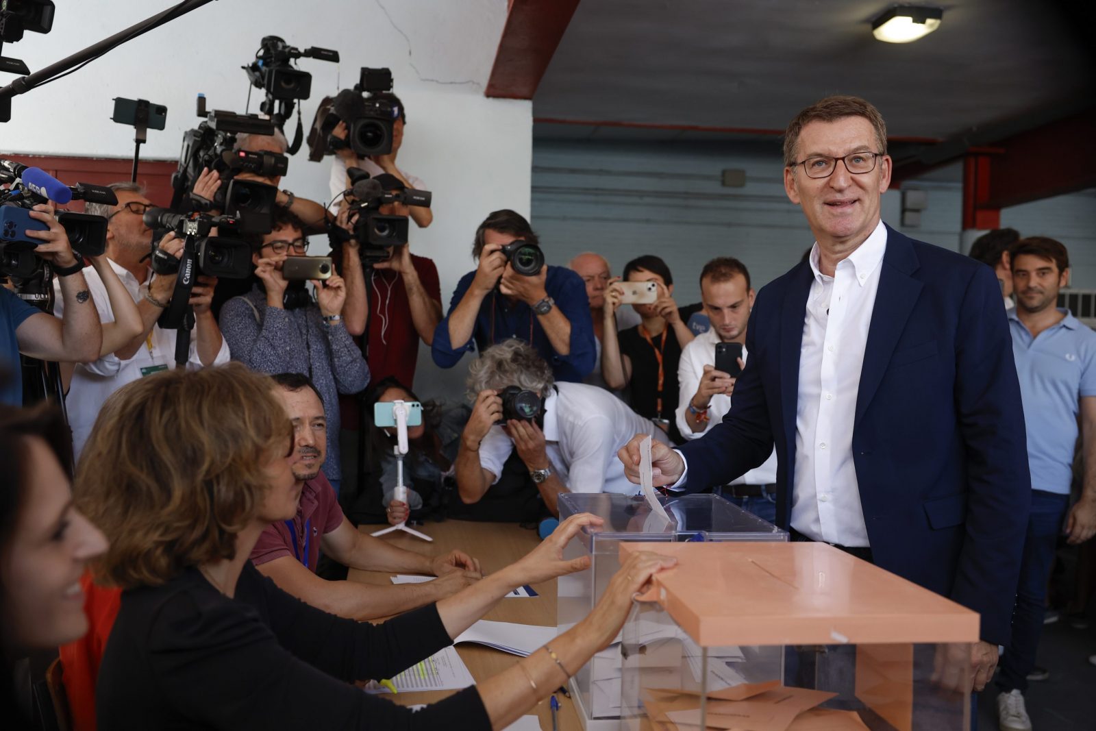 epa10763588 Spanish main opposition People's Party leader and candidate for Prime Minister Alberto Nunez Feijoo (R) casts his ballot for the general elections at a polling station in Madrid, Spain, 23 July 2023. Spanish voters head to polling stations on 23 July to vote for the lower and the upper house of the country's parliament.  EPA/CHEMA MOYA