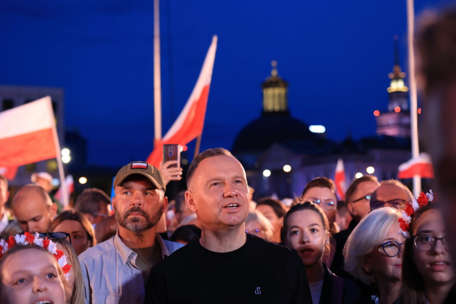 epa10780411 Polish President Andrzej Duda (C) attends a patriotic concert during the 79th anniversary of the outbreak of Warsaw Uprising at Jozef Pilsudski Square in Warsaw, Poland, 01 August 2023. The Warsaw Uprising started on 01 August 1944 as the biggest resistance operation in Nazi-occupied Europe. Initially intended to last several days, it continued for over two months before being suppressed by the Germans. The uprising claimed the lives of about 18,000 insurgents and around 180,000 civilians.  EPA/Szymon Pulcyn POLAND OUT