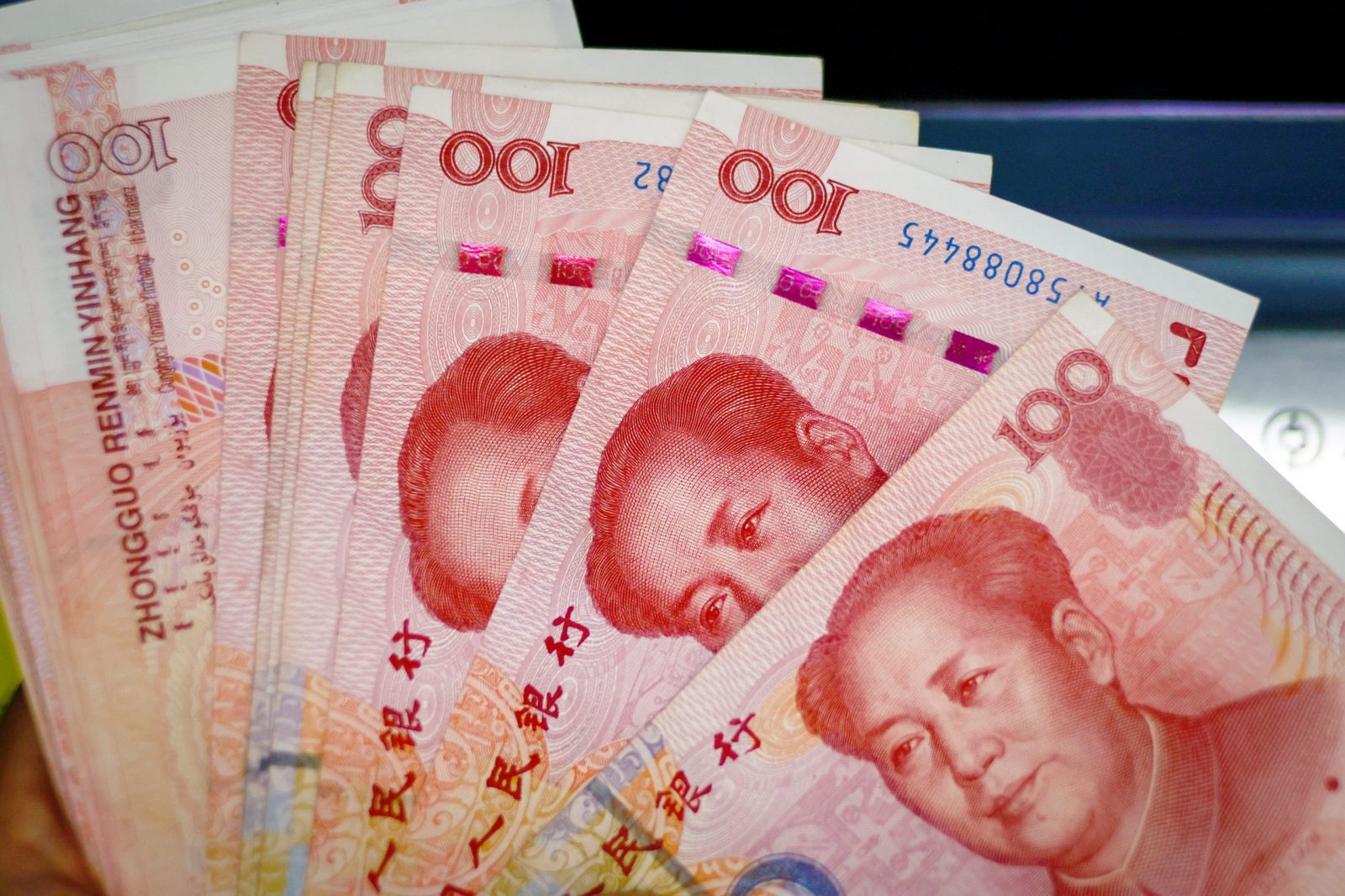 epa10791423 An illustration picture shows banknotes of 100 Chinese Yuan or Renminbi (RMB) in Beijing, China, 09 August 2023. China's consumer price index declined 0.3 percent in July compared to last year, National Bureau of Statistics said.  EPA/MARK R. CRISTINO