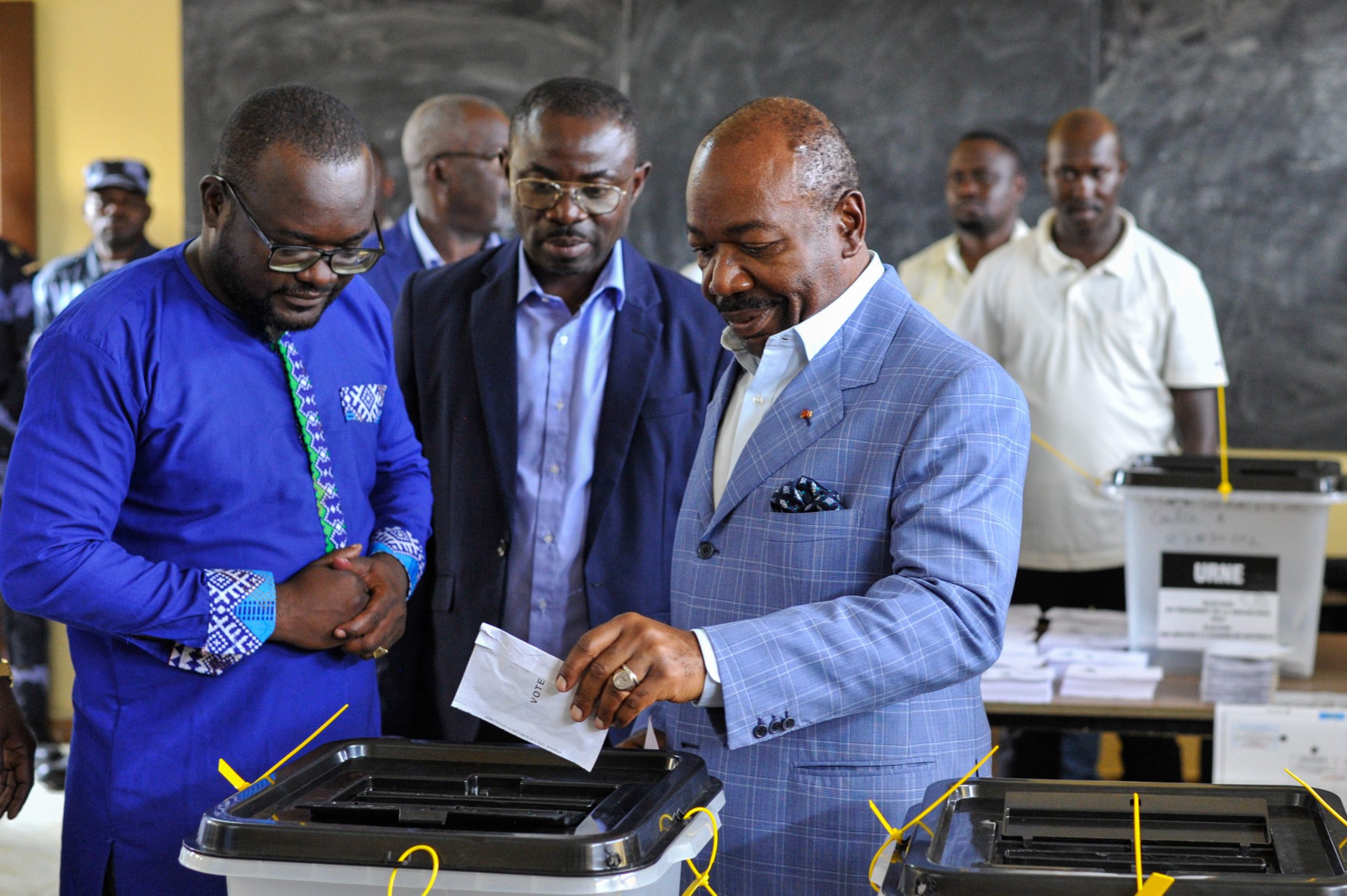 epa10821763 Gabonese President Ali Bongo Ondimba (R), prepares to cast his vote during the 2023 Gabonese general elections in Libreville, Gabon, 26 August 2023. A little under 850,000 registered voters out of a population of of 2.3 million are to decide whether to give President Ali Bongo Ondimba a third term.  EPA/STR