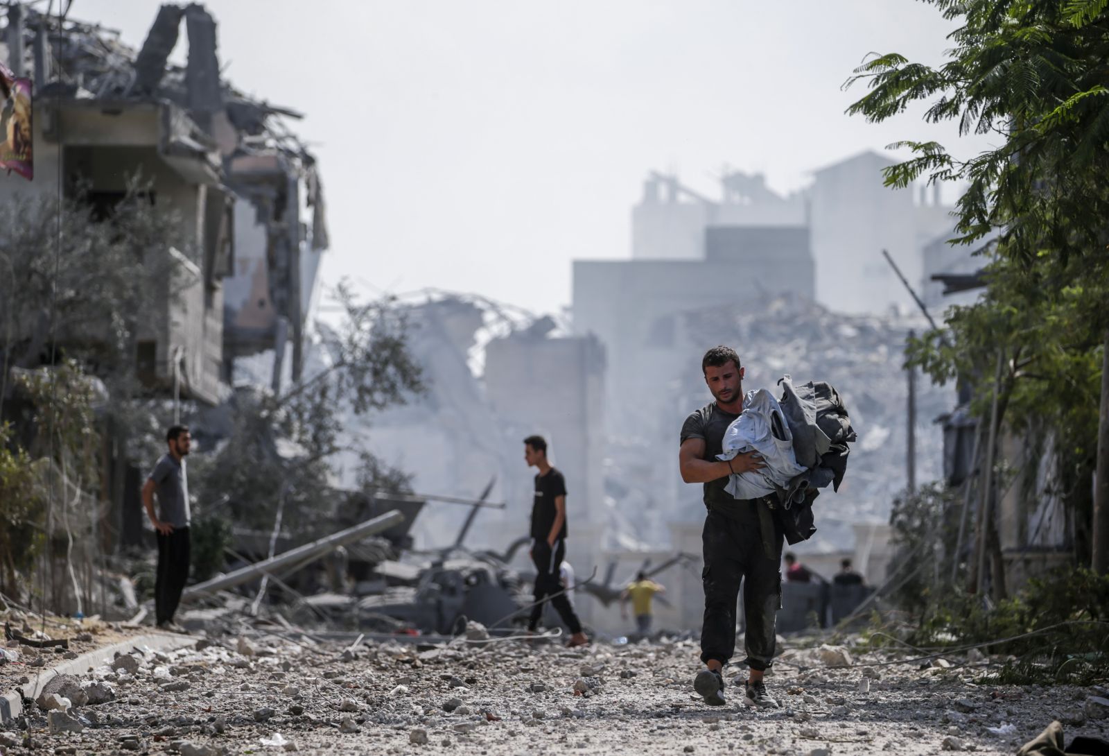 epa10911490 Palestinians stand in the destroyed Al-Ramal neighborhood following an Israeli air strike in Gaza City, 10 October 2023. More than 700 people have been killed and around 4,000 have been injured according to the Palestinian Ministry of Health, after Israel started bombing the Palestinian enclave in response to an attack carried out by the Islamist movement Hamas on 07 October. More than 3,000 people, including 1,500 militants from Hamas, have been killed and thousands injured in Gaza and Israel since 07 October, according to Israeli military sources and Palestinian officials.  EPA/MOHAMMED SABER