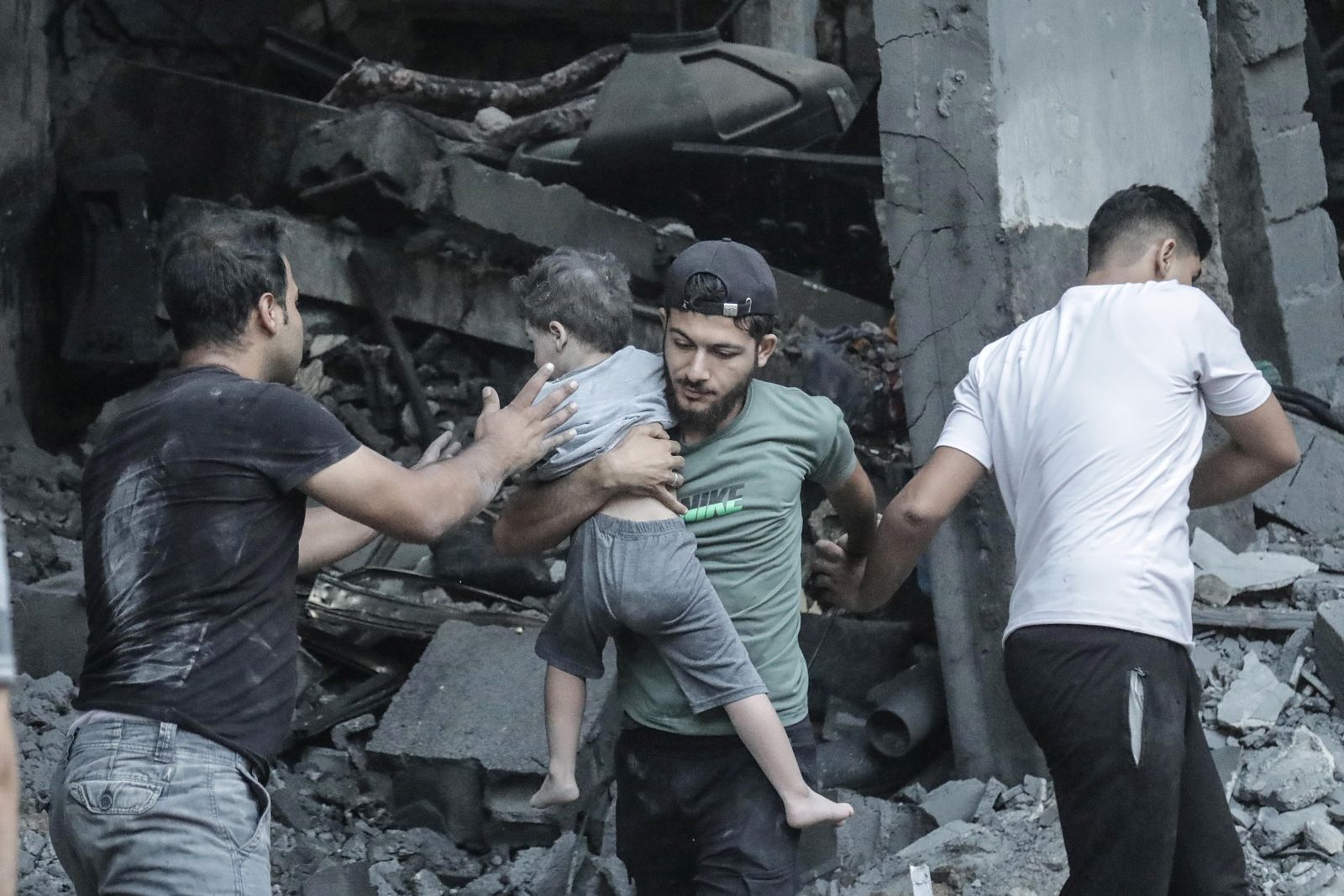 epa10926775 A child is recovered from the rubble of a residential building leveled in an Israeli airstrike, in Khan Younis refugee camp in the southern Gaza Strip, 19 October 2023. Israel has called for the evacuation of all civilians of northern Gaza ahead of an expected ground invasion. More than 1,400 Israelis have been killed and over 3,200 others injured, according to the IDF, after the Islamist movement Hamas launched an attack against Israel from the Gaza Strip on 07 October. More than 3,400 Palestinians have been killed and over 12,100 others injured in Gaza since Israel launched retaliatory air strikes, the Palestinian health ministry said.  EPA/HAITHAM IMAD