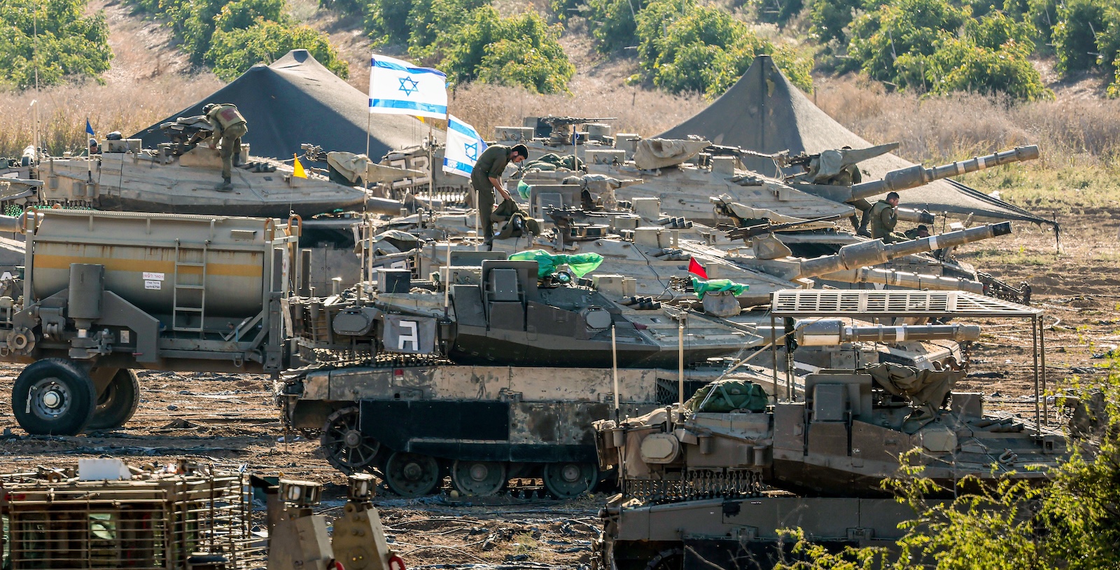 epa10930312 Israeli soldiers and armored vehicles are gathered at an undisclosed location near the border with Gaza, in Israel, 21 October 2023. More than 4,000 Palestinians and 1,400 Israelis have been killed according to the Israel Defense Forces (IDF) and the Palestinian health authority since Hamas militants launched an attack against Israel from the Gaza Strip on 07 October. In the latest developments, Egypt is due to host, on 21 October, an international summit on the situation in Gaza, and after a Qatari mediation, two hostages have been released by Hamas on the evening of 20 October as confirmed by their relatives, Israeli officials and Hamas.  EPA/HANNIBAL HANSCHKE