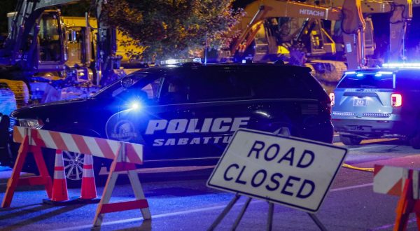 epa10939780 A police car drives past a road block sign on the road leading to Schemengees bar where a man reportedly opened fire killing and injuring numerous people in Lewiston, Maine, USA, 25 October 2023. Early reports indicate as many as 20 people have been killed, and dozens injured. Police are still searching for the suspect.  EPA/CJ GUNTHER