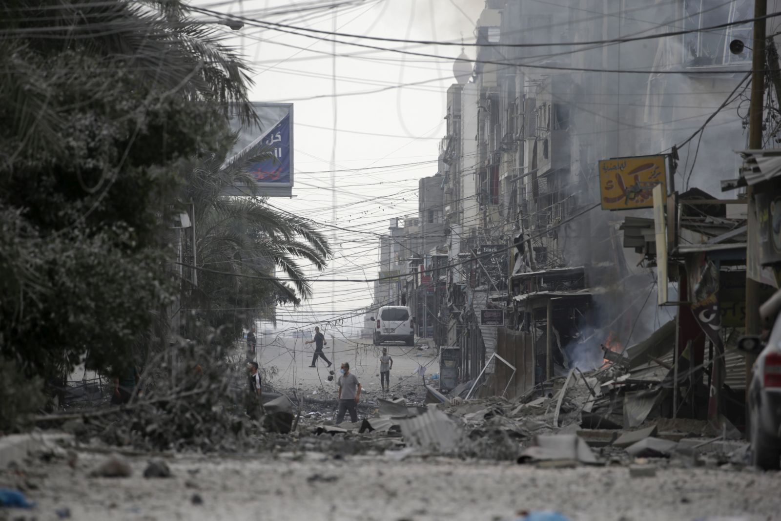 epa10942513 Palestinians walk among the rubble of destroyed buildings following Israeli air strikes in Gaza City, 27 October 2023. More than 7,000 Palestinians and at least 1,300 Israelis have been killed, according to the Israel Defense Forces (IDF) and the Palestinian health authority, since Hamas militants launched an attack against Israel from the Gaza Strip on 07 October, and the Israeli operations in Gaza and the West Bank which followed it.  EPA/MOHAMMED SABER