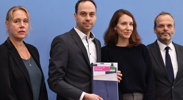 epa10961952 Nikolas Lelle of the Amadeu Antonio Foundation (2-L) holds a report with the title 
'Attacks on remembrance' as he poses with social psychologist and professor of social work, Beate Kuepper (L), Director of the House of the Wannsee Conference Memorial and Educational Site, Deborah Hartmann (3-L), and Federal Government Commissioner for Jewish Life in Germany and the Fight against Anti-Semitism, Felix Klein (R), during a press conference at the Federal Press Conference in Berlin, Germany, 07 November 2023. Federal Government Commissioner for Jewish Life in Germany and the Fight against Anti-Semitism, Felix Klein, presented the 12th edition of the Civil Society Anti-Semitism Situation Report, titled 'Jewish life and the memory of National Socialism are under massive attack'.  EPA/CLEMENS BILAN