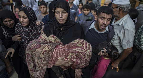 epa10964263 A woman carries the body of her child, killed in an air strike on a house in the Khan Younis refugee camp, southern Gaza Strip, 08 November 2023. The Israel Defence Forces (IDF) said on 08 November that their troops continue to operate inside the Gaza Strip, directing aircraft strikes on Hamas infrastructures. More than 10,000 Palestinians and at least 1,400 Israelis have been killed, according to the Israel Defense Forces (IDF) and the Palestinian health authority, since Hamas militants launched an attack against Israel from the Gaza Strip on 07 October, and the Israeli operations in Gaza and the West Bank which followed it.  EPA/HAITHAM IMAD