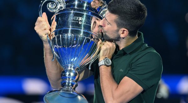 epa10973300 Novak Djokovic of Serbia poses with the trophy awarded for the ATP Year-End Number One in the world ranking, during the Nitto ATP Finals 2023 tennis tournament in Turin, Italy, 13 November 2023.  EPA/Alessandro Di Marco