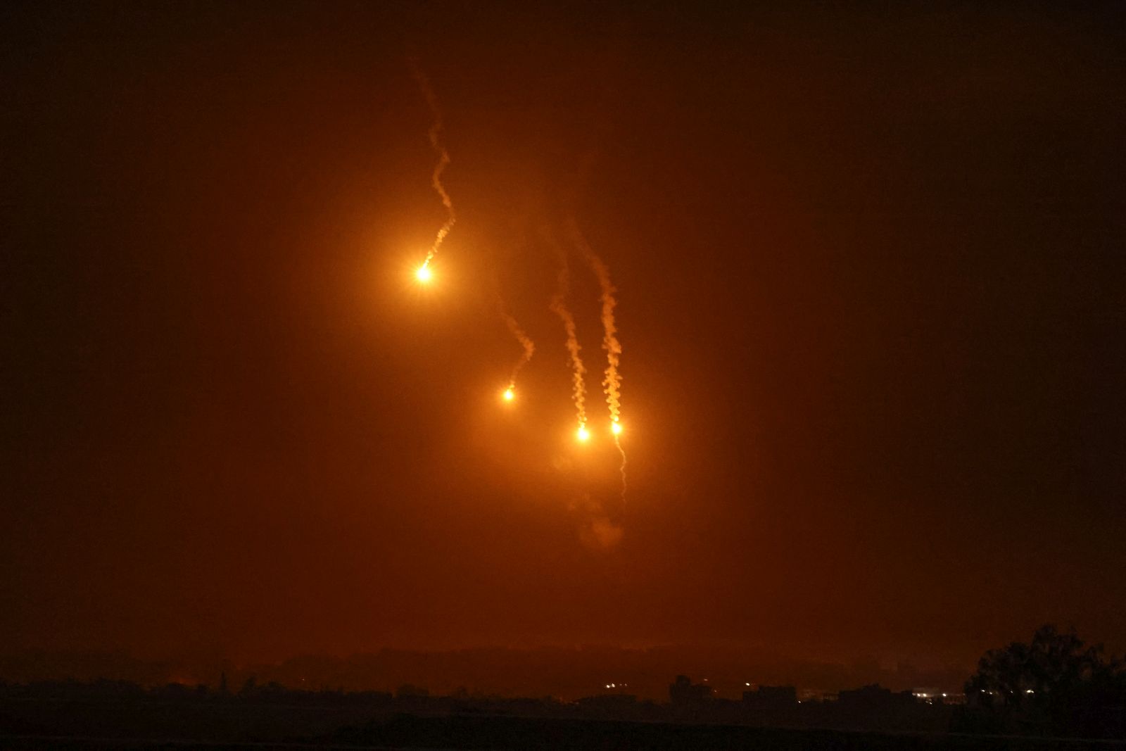 epa10976612 Flares over Beit Hanoun, in the northern Gaza Strip, as seen from Sderot, southern Israel, 15 November 2023. More than 11,000 Palestinians and at least 1,200 Israelis have been killed, according to the Israel Defense Forces (IDF) and the Palestinian health authority, since Hamas militants launched an attack against Israel from the Gaza Strip on 07 October, and the Israeli operations in Gaza and the West Bank which followed it.  EPA/ATEF SAFADI