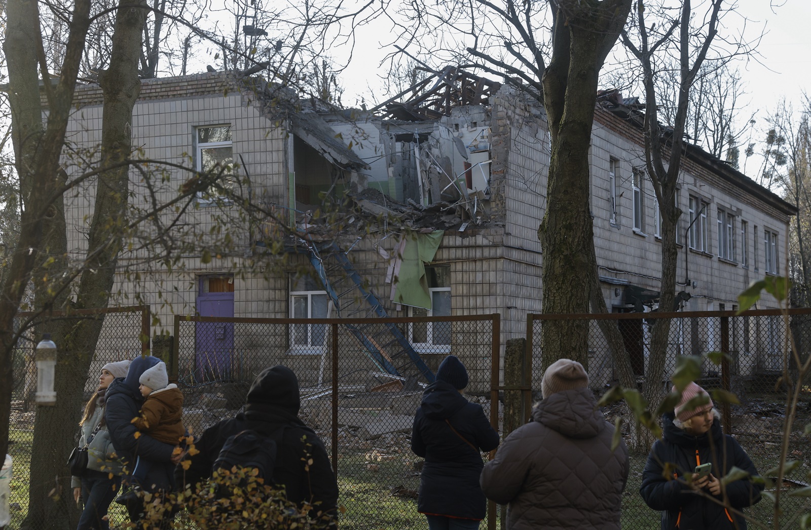 epa10993820 People view the rubble of a kindergarten damaged during drone strikes in Kyiv, Ukraine 25 November 2023. Ukraine's Air Force Command of the Armed Forces said it downed 71 of 75 drones in an overnight attack, 25 November, in what Kyiv authorities called the most intense attack on the capital since the start of the invasion.  Russian troops entered Ukrainian territory in February 2022, starting a conflict that has provoked destruction and a humanitarian crisis.  EPA/SERGEY DOLZHENKO