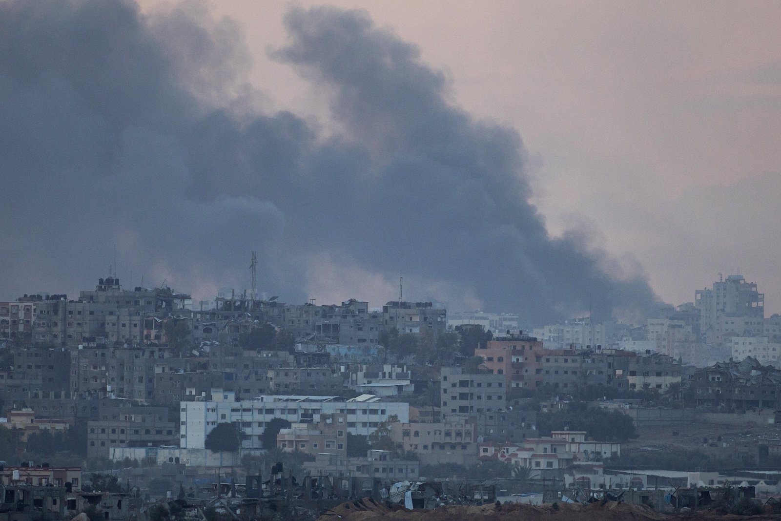 epa10999181 Smoke rises over damaged buildings on the northern part of the Gaza Strip, as seen from Sderot, southern Israel, 28 November 2023. The Israeli Defense Forces (IDF) announced on 28 November that three explosive devices were detonated near IDF troops in two locations in the northern Gaza Strip, in what it called a violation of 'the framework of the operational pause'. In one of the locations, Israeli troops were shot at and responded with fire. A number of soldiers were 'lightly injured' in the incidents, the statement added. Israel and Hamas agreed to a four-day ceasefire, mediated by Qatar, the US, and Egypt, that came into effect at 05:00 AM GMT on 24 November. On 27 November the ceasefire was extended by 48 hours.  EPA/CHRISTOPHE PETIT TESSON