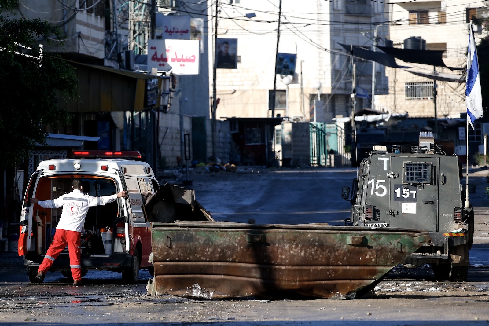 epa11028187 An ambulance trying to reach Jenin Hospital is stopped for search by the Israeli forces as their raid on Jenin refugee camp enters a third consecutive day, near the West Bank city of Jenin, 14 December 2023. According to the Palestinian Health Ministry, at least 11 Palestinians have been killed in Jenin since 12 December during Israeli military raids. Thousands of Israelis and Palestinians have died since the militant group Hamas launched an unprecedented attack on Israel from the Gaza Strip on 07 October, and the Israeli operations in Gaza and the West Bank which followed it.  EPA/ALAA BADARNEH