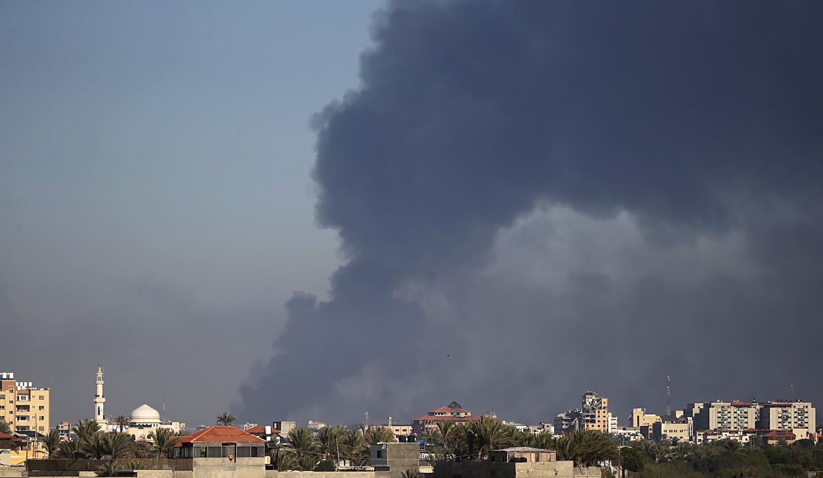 epa11035870 Smoke rises following Israeli air strikes in Gaza City, seen from Al Nusairat refugee camp, southern Gaza Strip, 18 December 2023. More than 60 members from two families were killed after an Israeli air strike, Palestinians civil defense said.  Israeli forces resumed military strikes on Gaza after a week-long truce expired on 01 December. More than 18,000 Palestinians and at least 1,200 Israelis have been killed, according to the Palestinian Health Ministry and the Israel Defense Forces (IDF), since Hamas militants launched an attack against Israel from the Gaza Strip on 07 October, and the Israeli operations in Gaza and the West Bank which followed it.  EPA/MOHAMMED SABER