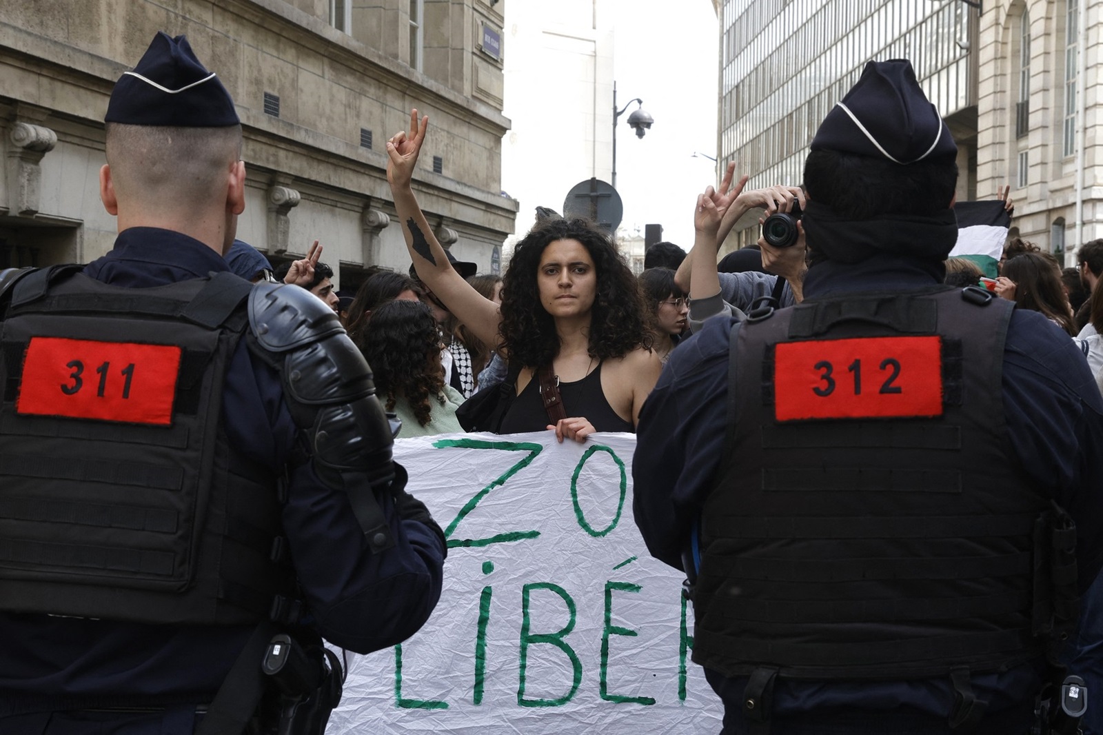 A protester make a victory sign during a rally in support of Palestinians at the Sorbonne University in Paris on April 29, 2024. Students gathered at midday on April 29, 2024 at the Sorbonne to express their support for the Palestinians in front of the building and inside the university, where they set up tents, following the similar action at Sciences Po of April 26, 2024, a day of blockades and mobilisation, marked by tensions.,Image: 868839876, License: Rights-managed, Restrictions: , Model Release: no, Credit line: Geoffroy VAN DER HASSELT / AFP / Profimedia