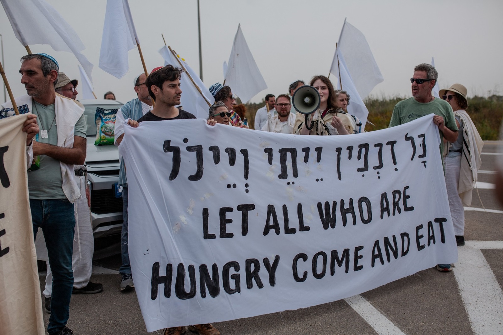 Activists hold a sign during a protest near the Gaza strip border in Israel on Friday, April 26, 2024. Rabbis belonging to the U.S.-based organization "Rabbis for Ceasefire," along with Israeli rabbis and activists, gathered near the Gaza border in an attempt to make a symbolic delivery of aid through Erez Crossing. The Israeli police stopped the procession, prevented the delivery of aid, and arrested seven rabbis and activists. The activists are calling for a permanent ceasefire and an end to the human-made starvation in Gaza. Israel-Gaza border , Erez crossing, on April 26, 2024.,Image: 868327935, License: Rights-managed, Restrictions: , Model Release: no, Credit line: Middle East Images/ABACA / Abaca Press / Profimedia