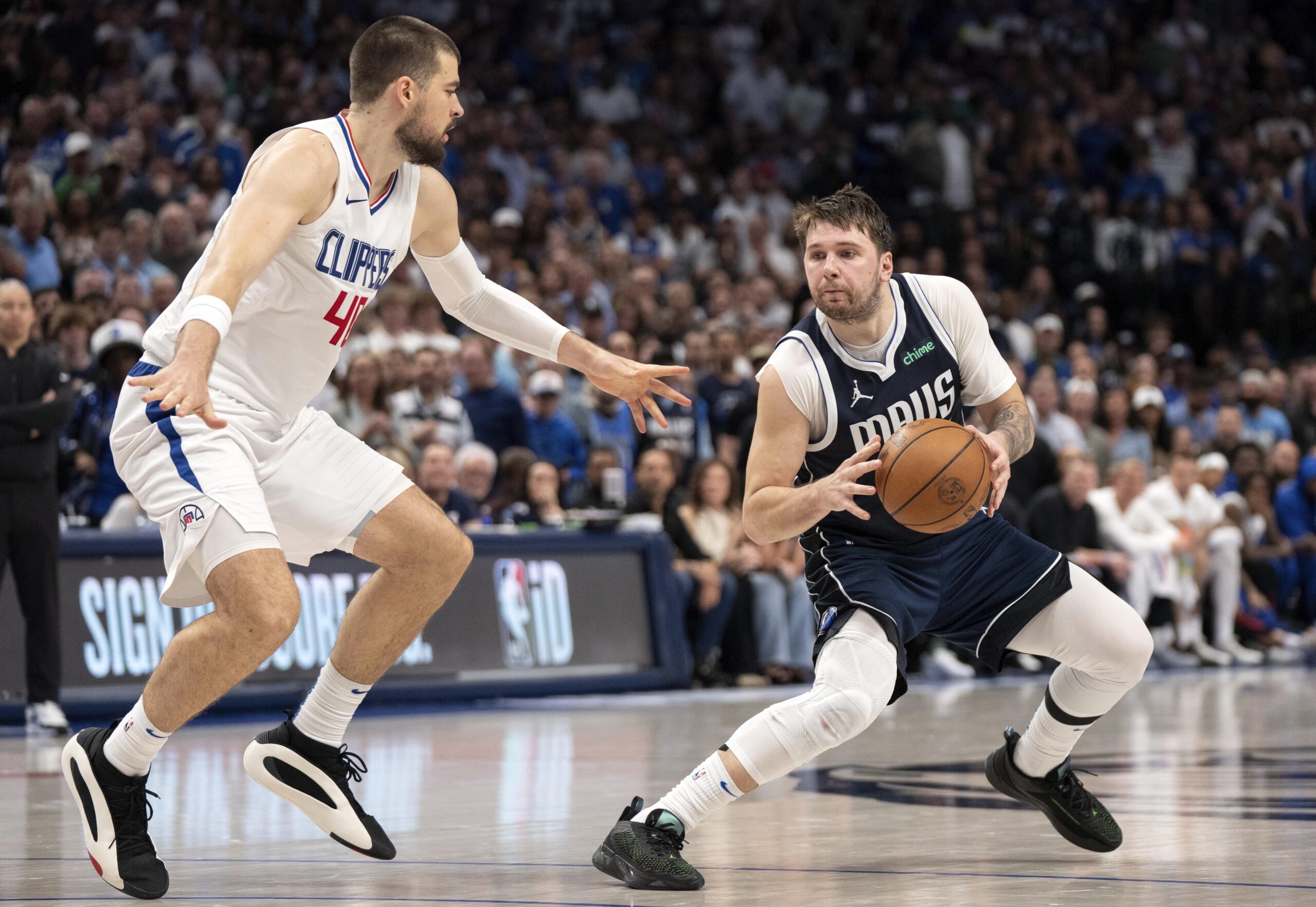 Dallas Mavericks guard Luka Doncic steps back in front of Los Angeles Clippers center Ivica Zubac (40) during Game 4 of an NBA basketball first-round playoff series Sunday, April 28, 2024, in Dallas. (AP Photo/Jeffrey McWhorter)