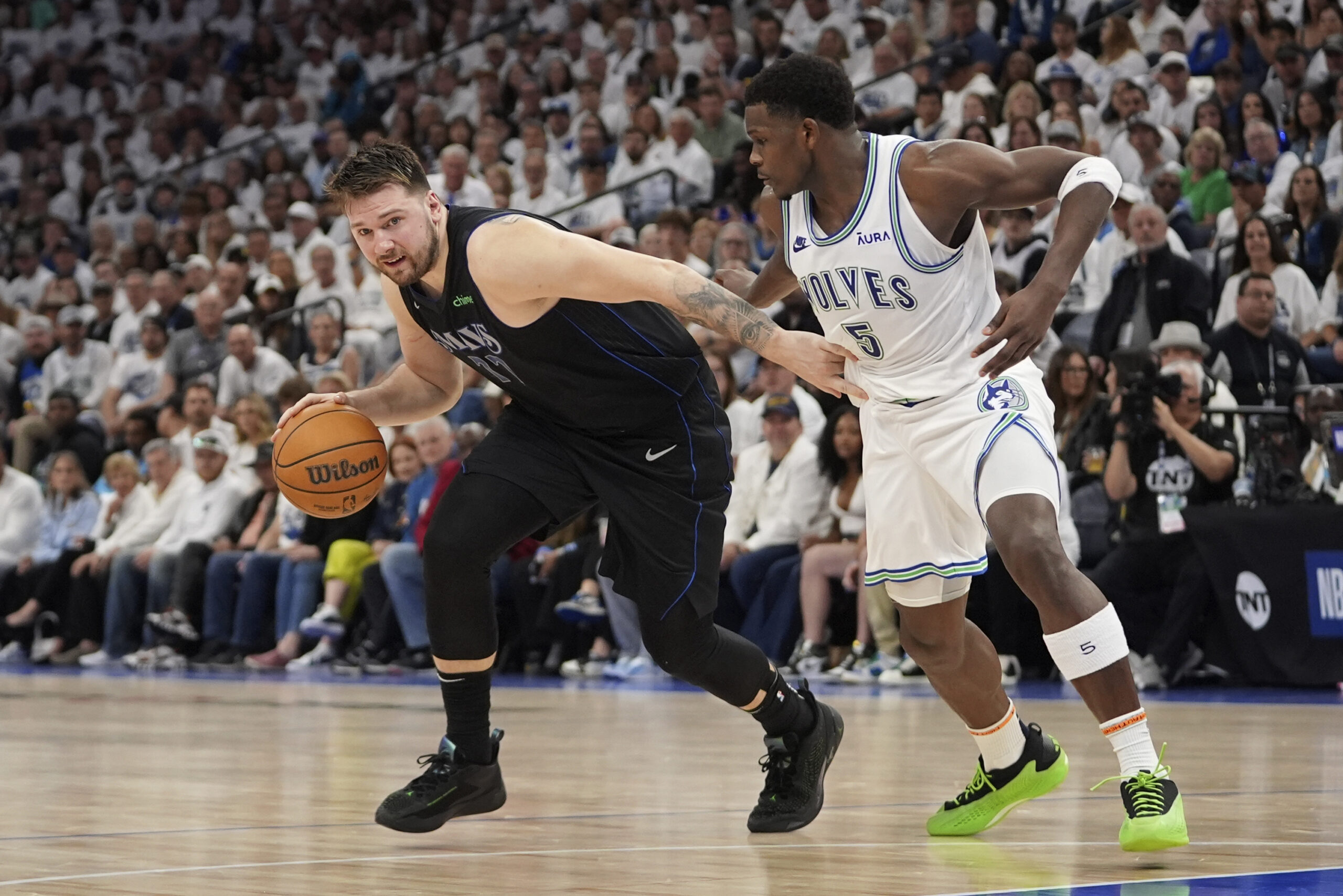 Dallas Mavericks guard Luka Doncic (77) drives against Minnesota Timberwolves guard Anthony Edwards (5) during the first half of Game 2 of the NBA basketball Western Conference finals, Friday, May 24, 2024, in Minneapolis. (AP Photo/Abbie Parr)