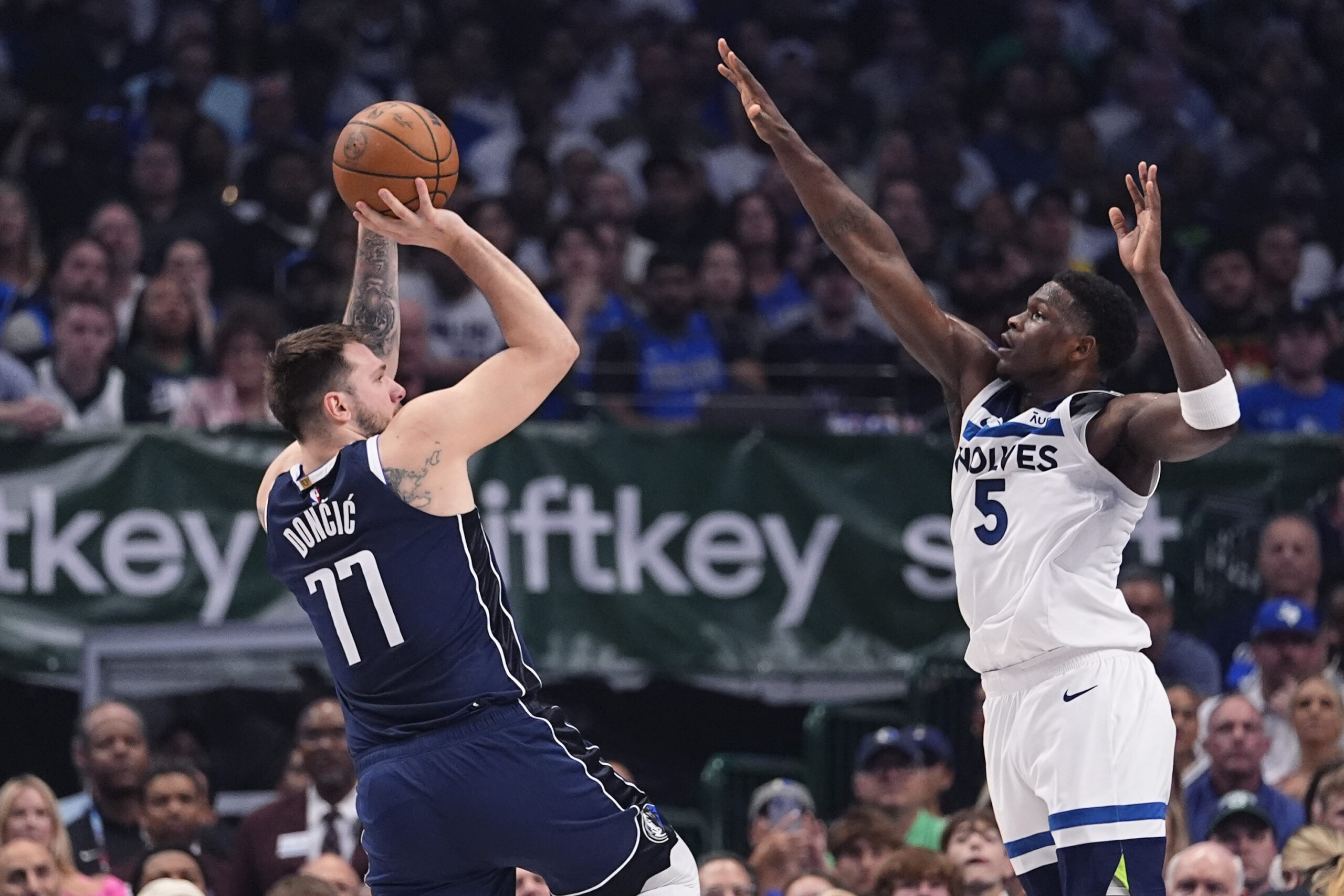 Dallas Mavericks guard Luka Doncic (77) shoots against Minnesota Timberwolves guard Anthony Edwards (5) during the first half in Game 4 of the NBA basketball Western Conference finals, Tuesday, May 28, 2024, in Dallas. (AP Photo/Julio Cortez)