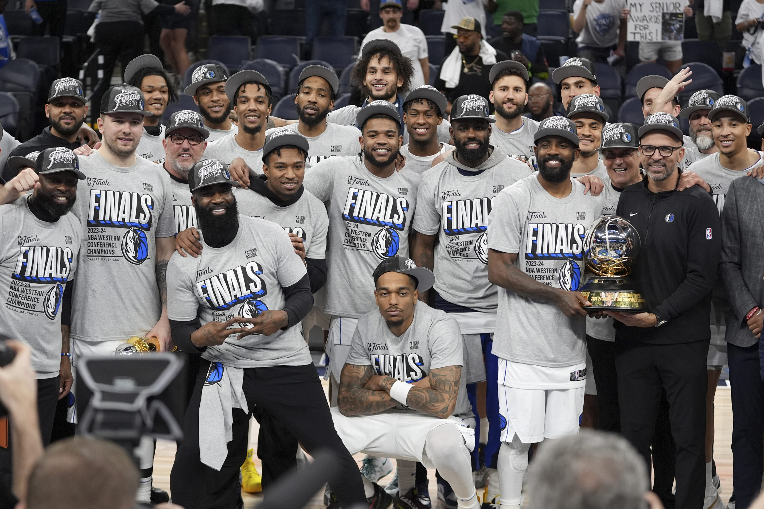 The Dallas Mavericks celebrate as they pose for a team photograph after Game 5 of the Western Conference finals in the NBA basketball playoffs against the Minnesota Timberwolves, Thursday, May 30, 2024, in Minneapolis. The Mavericks won 124-103, taking the series 4-1 and moving on to the NBA Finals. (AP Photo/Abbie Parr)