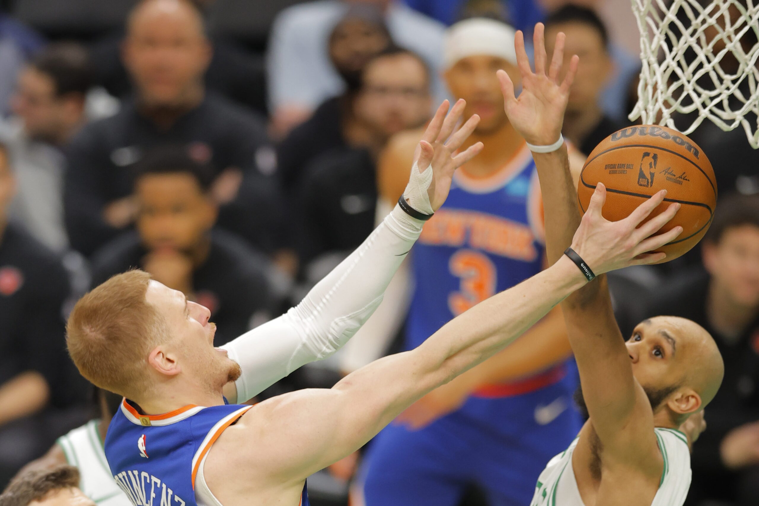 epa11274095 New York Knicks guard Donte DiVincenzo (L) shoots around Boston Celtics guard Derrick White (R) during the first half of the NBA game between the Boston Celtics and the New York Knicks in Boston, Massachusetts, USA, 11 April 2024.  EPA/CJ GUNTHER  SHUTTERSTOCK OUT