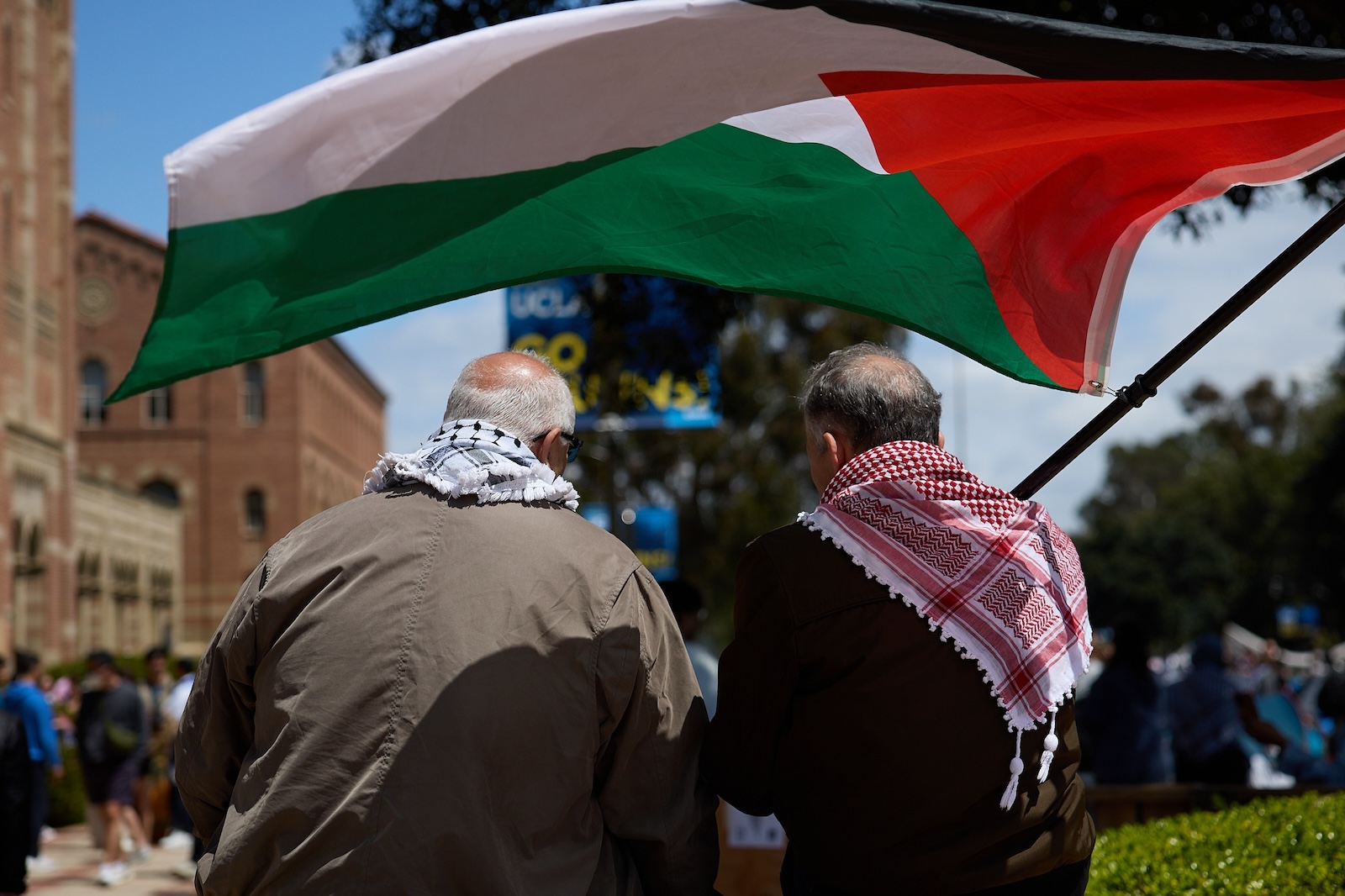 epa11301414 Two men wave the Palestinian flag as University of California Los Angeles (UCLA) students set up a Gaza solidarity encampment on campus to advocate for Palestine in Los Angeles, California, USA, 25 April 2024. More than 34,000 Palestinians and over 1,450 Israelis have been killed, according to the Palestinian Health Ministry and the Israel Defense Forces (IDF), since Hamas militants launched an attack against Israel from the Gaza Strip on 07 October 2023, and the Israeli operations in Gaza and the West Bank which followed it.  EPA/ALLISON DINNER