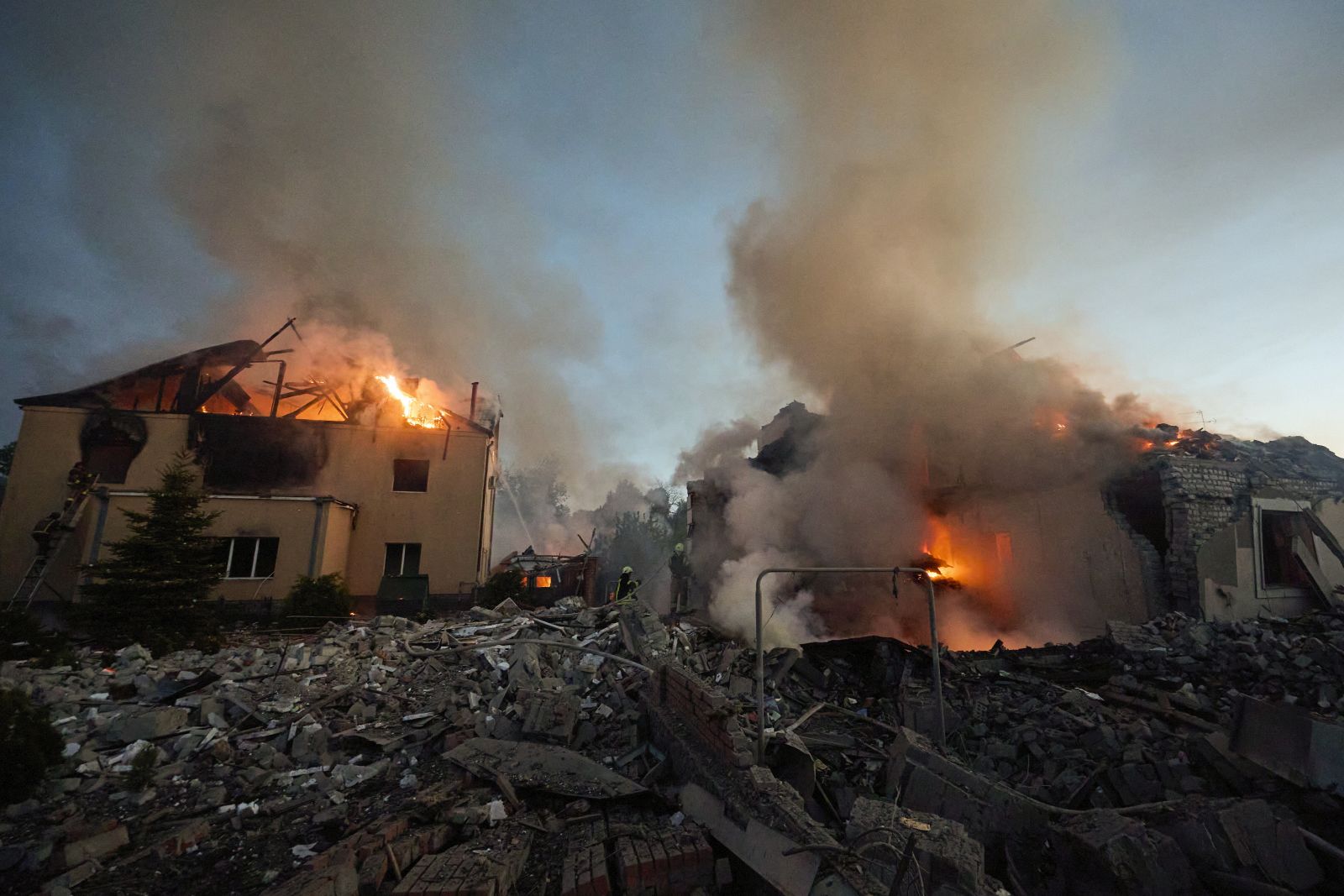 epa11330779 Ukrainian rescuers work to extinguish a fire at the site of an overnight missile strike on private buildings in Kharkiv, northeastern Ukraine, 10 May 2024, amid the Russian invasion. Kharkiv was hit by an S-300 missile at night, Mayor Ihor Terekhov wrote on telegram. At least two people, a 11-year-old child and a 72-year-old woman, were injured in the attack, according to the head of the Kharkiv Regional Military Administration, Oleg Synegubov. Russian troops entered Ukrainian territory on 24 February 2022, starting a conflict that has provoked destruction and a humanitarian crisis.  EPA/SERGEY KOZLOV