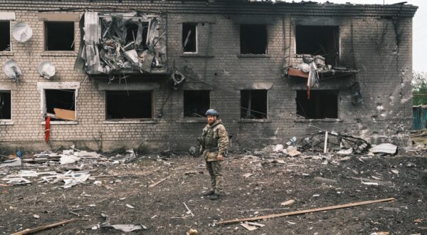 epa11336743 A Ukrainian police officer inspects a damaged building during the evacuation of local people from territories bordering Russia, in the city of Vovchansk, Kharkiv region, northeastern Ukraine, 13 May 2024, amid the Russian invasion. More than 4,000 residents from settlements in areas of the Kharkiv region bordering Russia have been evacuated as 'hostilities intensified', the head of the Kharkiv Military Administration Oleg Synegubov wrote on telegram. The evacuations follow a cross-border offensive by Russian forces, who claimed the capture of several villages in the region. Russian troops entered Ukrainian territory on 24 February 2022, starting a conflict that has provoked destruction and a humanitarian crisis.  EPA/GEORGE IVANCHENKO