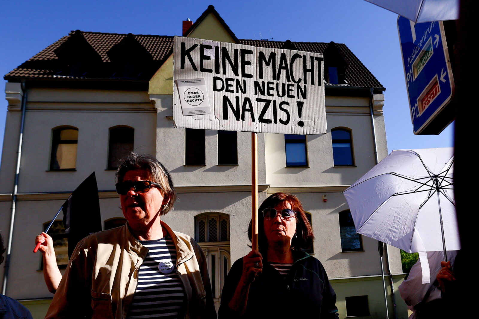 epa11338937 People carry a placard reading 'doing nothing makes the new Nazis' during a protest against the current leader of the far-right Alternative for Germany (AfD) political party in the state of Thuringia, Bjoern Hoecke, on the sidelines of his trial for using Nazi-era terminology, outside the court in Halle, Germany, 14 May 2024. Prosecutors accuse Hoecke of having concluded a political rally in Merseburg in 2021 by yelling out 'Alles fuer Deutschland' (Everything for Germany), a slogan used by Nazi-era SA stormtroopers, the use of which is a felony in modern Germany. The state of Thuringia is among three Eastern German states scheduled to hold state elections in September 2024, and in all three the AfD is currently leading in polls.  EPA/FILIP SINGER