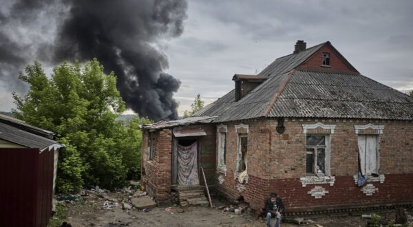 epa11348680 A local man sits near his damaged home as smoke rises after shelling, on the outskirts of Kharkiv, Ukraine, 17 May 2024, amid the Russian invasion. More than 9,000 residents from settlements in areas of the Kharkiv region bordering Russia have been evacuated as hostilities intensified, the head of the Kharkiv Military Administration Oleg Synegubov said on 17 May. The evacuations follow a cross-border offensive by Russian forces, who claimed the capture of several villages in the region. Russian troops entered Ukrainian territory on 24 February 2022, starting a conflict that has provoked destruction and a humanitarian crisis.  EPA/SERGEY KOZLOV