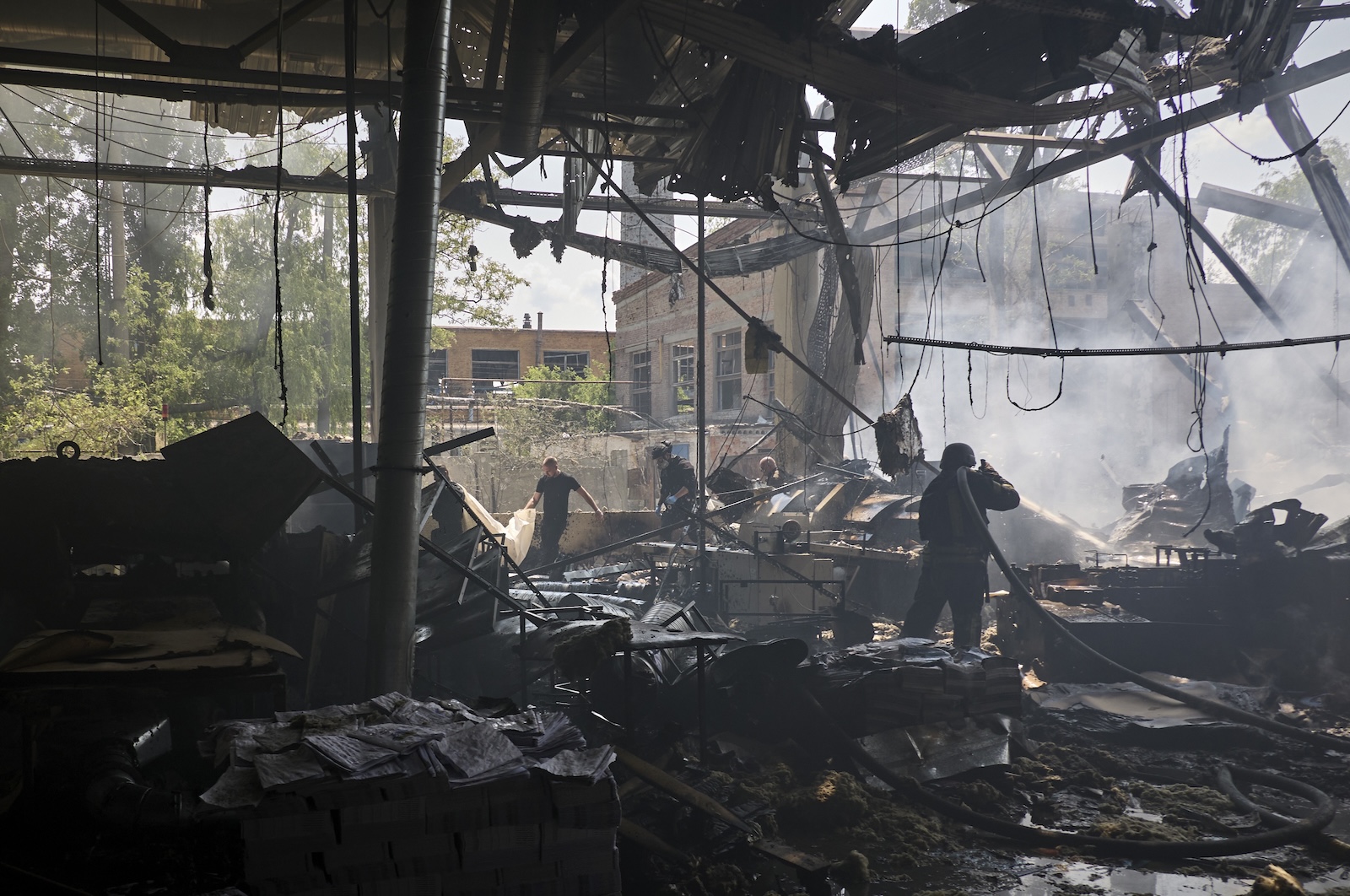 epa11363329 Ukrainian rescuers work at the site of a shelling on a printing house in Kharkiv, Ukraine, 23 May 2024, amid the Russian invasion. At least seven people were killed and 16 others were wounded in the rocket attack, according to the report of the head of the Kharkiv Military Administration Oleg Synegubov.  EPA/SERGEY KOZLOV