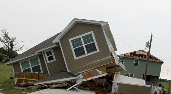 epa11364551 A general view of a house leaning on its side after being hit by a tornado in Temple, Texas, USA, 23 May 2024. According to Temple's fire chief Mitch Randles about 30 people were injured and over 500 homes and businesses impacted, by the tornado that hit Temple on 22 May.  EPA/Adam Davis