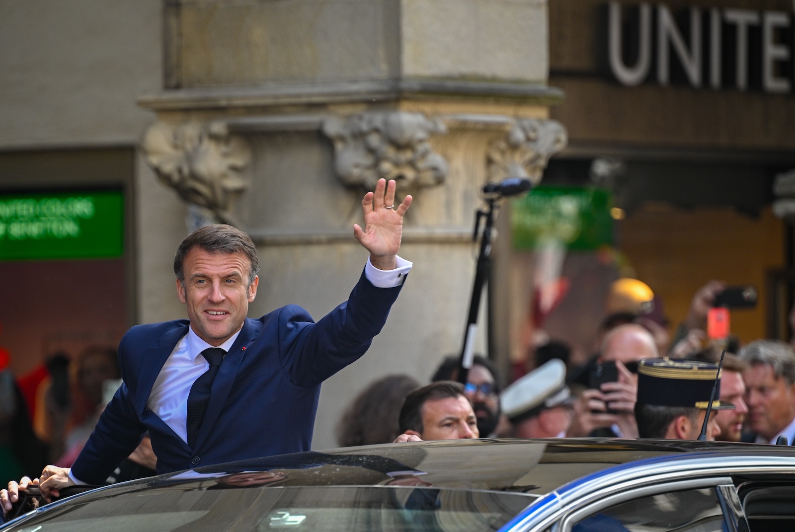 epa11375405 French President Emmanuel Macron (L) waves as he leaves the historical city hall on the third day of his state visit to Germany, in Muenster, Germany, 28 May 2024. Macron is on a three-day visit to Germany with stops in Berlin, Dresden, Moritzburg and Muenster. He will return to Berlin to take part in a gathering of the French and German governments at Meseberg Palace later on 28 May.  EPA/SASCHA SCHUERMANN / POOL