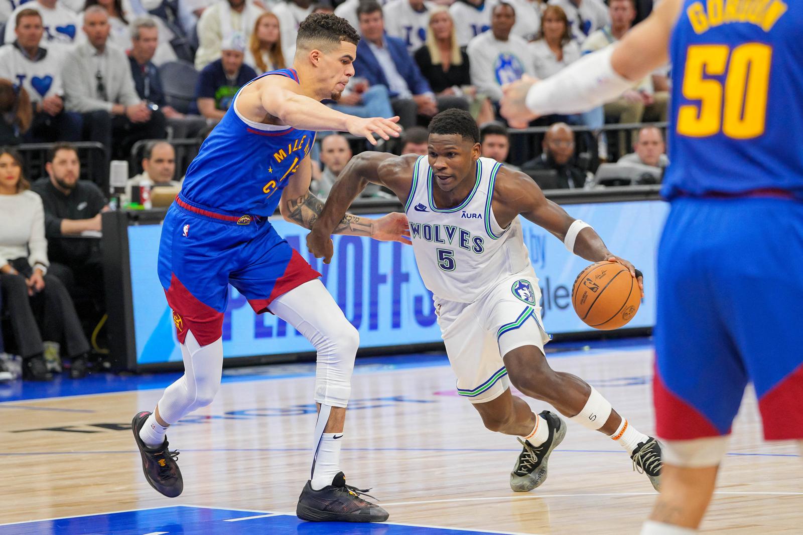 May 16, 2024; Minneapolis, Minnesota, USA; Minnesota Timberwolves guard Anthony Edwards (5) dribbles against the Denver Nuggets forward Michael Porter Jr. (1) in the third quarter during game six of the second round for the 2024 NBA playoffs at Target Center. Mandatory Credit: Brad Rempel-USA TODAY Sports Photo: Brad Rempel/REUTERS