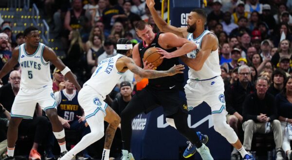May 19, 2024; Denver, Colorado, USA; Minnesota Timberwolves center Rudy Gobert (27) and guard Nickeil Alexander-Walker (9) defend Denver Nuggets center Nikola Jokic (15) in the first half in game seven of the second round for the 2024 NBA playoffs at Ball Arena. Mandatory Credit: Ron Chenoy-USA TODAY Sports Photo: Ron Chenoy/REUTERS