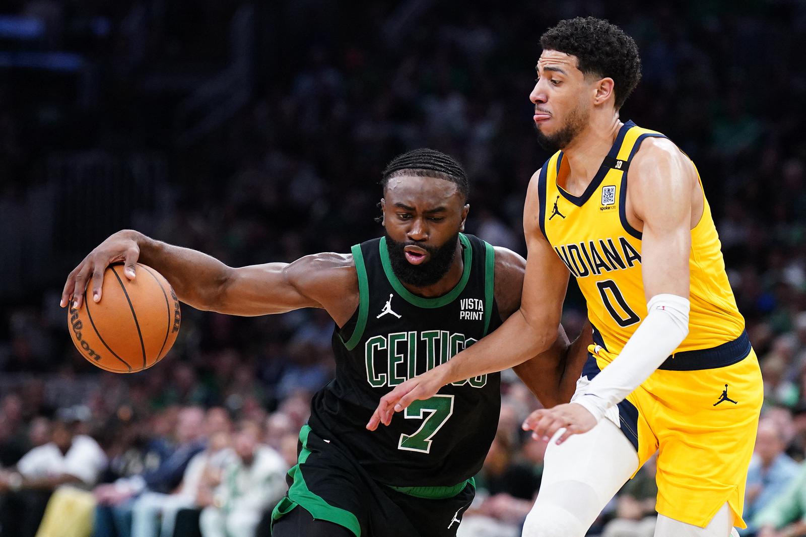 May 23, 2024; Boston, Massachusetts, USA; Boston Celtics guard Jaylen Brown (7) dribbles the ball against Indiana Pacers guard Tyrese Haliburton (0) in the first half during game two of the eastern conference finals for the 2024 NBA playoffs at TD Garden. Mandatory Credit: David Butler II-USA TODAY Sports Photo: David Butler II/REUTERS