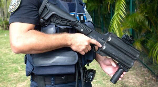 A municipal police officer equipped with flashballs keep watch near the N'Gea traffic circle, where activists are gathered, in Noumea on May 15, 2024, amid protests linked to a debate on a constitutional bill aimed at enlarging the electorate for upcoming elections of the overseas French territory of New Caledonia.  One person was killed, hundreds more were injured, shops were looted and public buildings torched during a second night of rioting in New Caledonia, authorities said May 15, as anger over constitutional reforms from Paris boiled over.,Image: 873132616, License: Rights-managed, Restrictions: , Model Release: no, Credit line: Delphine Mayeur / AFP / Profimedia