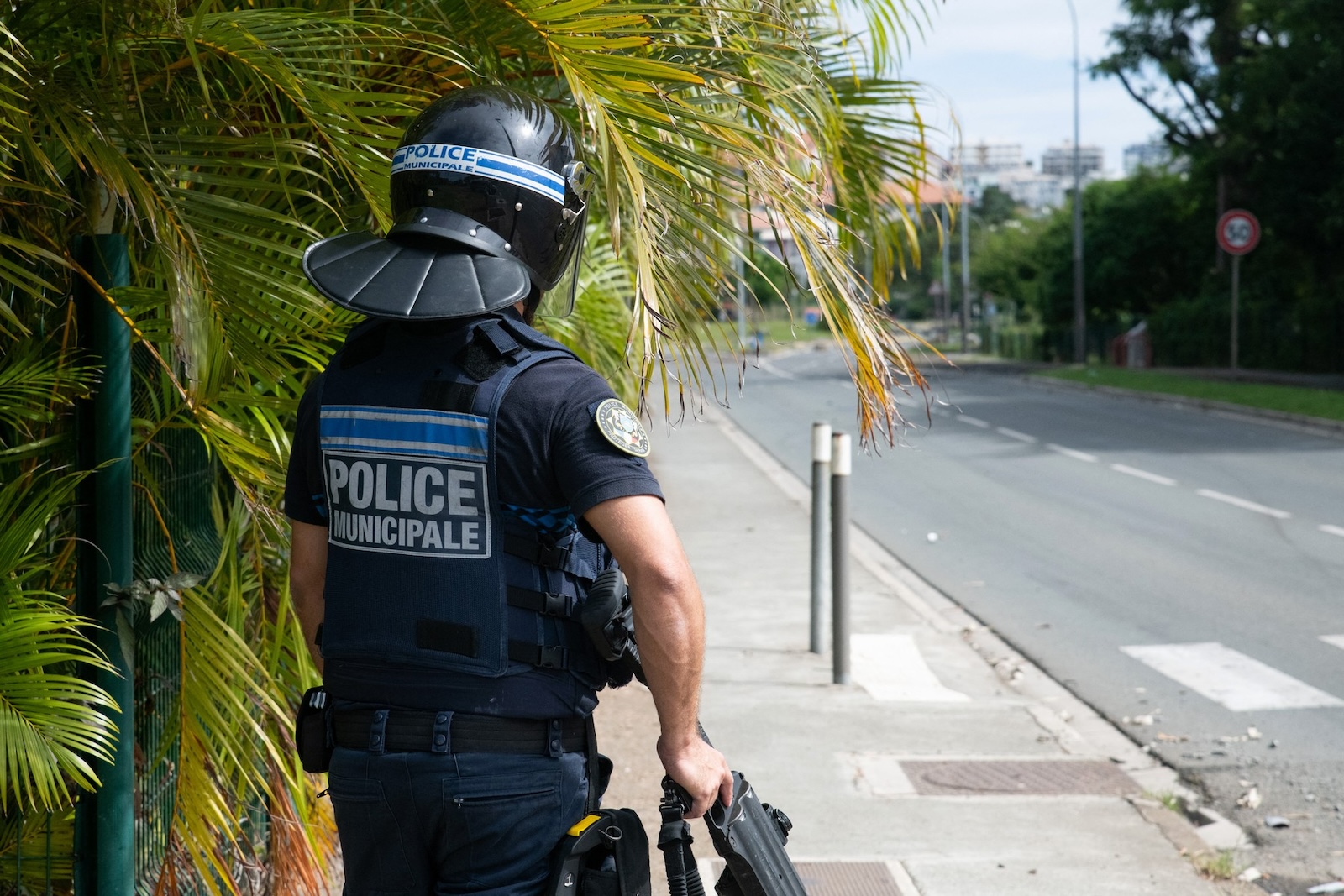 A municipal police officer equipped with flashballs keep watch near the N'Gea traffic circle, where activists are gathered, in Noumea on May 15, 2024, amid protests linked to a debate on a constitutional bill aimed at enlarging the electorate for upcoming elections of the overseas French territory of New Caledonia.  One person was killed, hundreds more were injured, shops were looted and public buildings torched during a second night of rioting in New Caledonia, authorities said May 15, as anger over constitutional reforms from Paris boiled over.,Image: 873132620, License: Rights-managed, Restrictions: , Model Release: no, Credit line: Delphine Mayeur / AFP / Profimedia