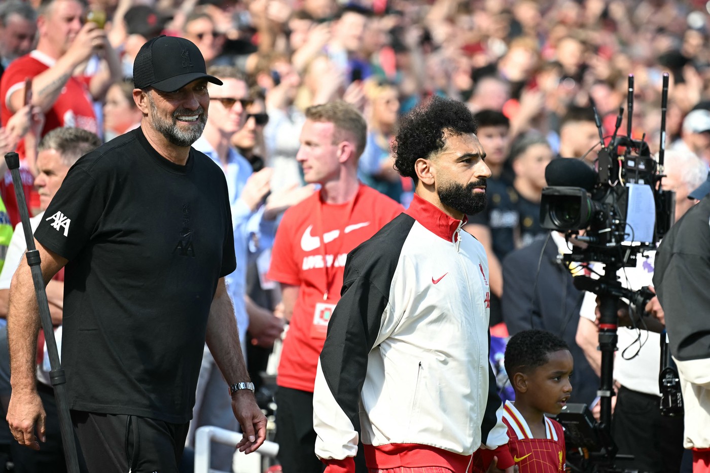 Liverpool's German manager Jurgen Klopp (L) walks out with Liverpool's Egyptian striker #11 Mohamed Salah (C) ahead of kick-off in the English Premier League football match between Liverpool and Wolverhampton Wanderers at Anfield in Liverpool, north west England on May 19, 2024. Jurgen Klopp said Friday he has experienced the "most intense" week of his life as he prepares to bring down the curtain on his trophy-filled Liverpool reign. Klopp, who arrived at the club in October 2015, won seven major trophies at Liverpool, including the club's first league title for 30 years and the 2019 Champions League.,Image: 874475889, License: Rights-managed, Restrictions: RESTRICTED TO EDITORIAL USE. No use with unauthorized audio, video, data, fixture lists, club/league logos or 'live' services. Online in-match use limited to 120 images. An additional 40 images may be used in extra time. No video emulation. Social media in-match use limited to 120 images. An additional 40 images may be used in extra time. No use in betting publications, games or single club/league/player publications., Model Release: no, Credit line: Paul ELLIS / AFP / Profimedia