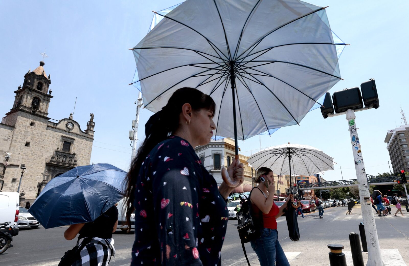 People protect themselves from the sun with an umbrella as they walk during a heat wave hitting the country in Guadalajara, Jalisco State, Mexico, on May 23, 2024.,Image: 875900248, License: Rights-managed, Restrictions: , Model Release: no, Credit line: ULISES RUIZ / AFP / Profimedia