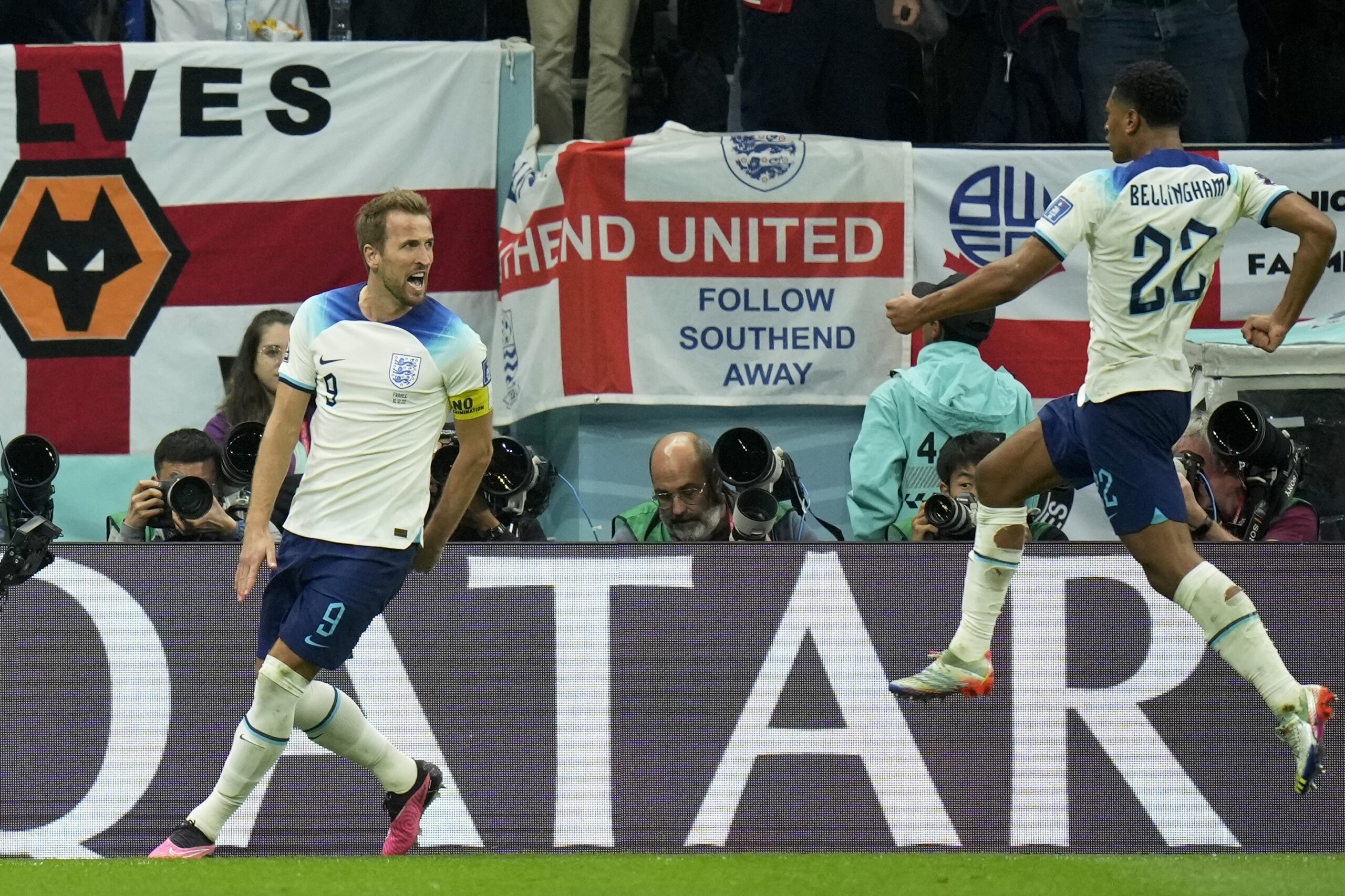 England's Harry Kane celebrates with Jude Bellingham, right, after scoring his side's first goal from the penalty spot during the World Cup quarterfinal soccer match between England and France, at the Al Bayt Stadium in Al Khor, Qatar, Saturday, Dec. 10, 2022. (AP Photo/Francisco Seco)